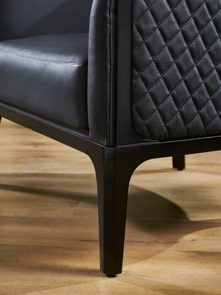 FN-5205-343329_7|Detail of modern black leather armchair's dark wooden tapered legs, highlighting robust construction and elegant contemporary design.