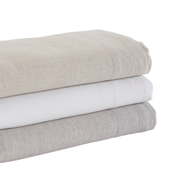 CSS-516-7284_6|Stack of natural 100% linen sheets in beige, white, and grey, providing luxurious comfort and breathable bedding.
