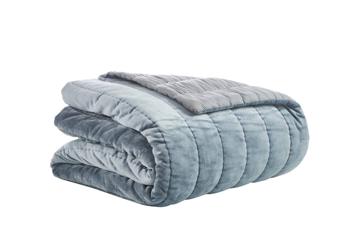 QT-360-11096_5|Folded blue velvet channel quilt, offering luxurious softness and cozy comfort. Perfect for stylish bedroom layering.