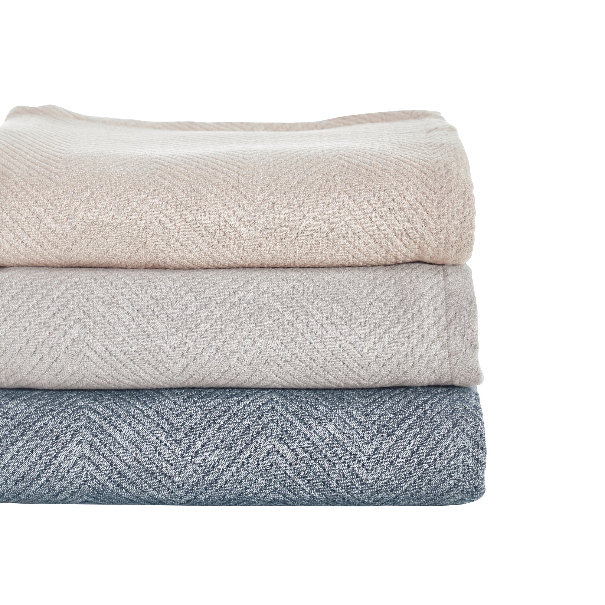 BT-123-11096_3|Stack of three chevron throw blankets: light beige, pale gray, and blue. Stylish, textured blankets for versatile decor.