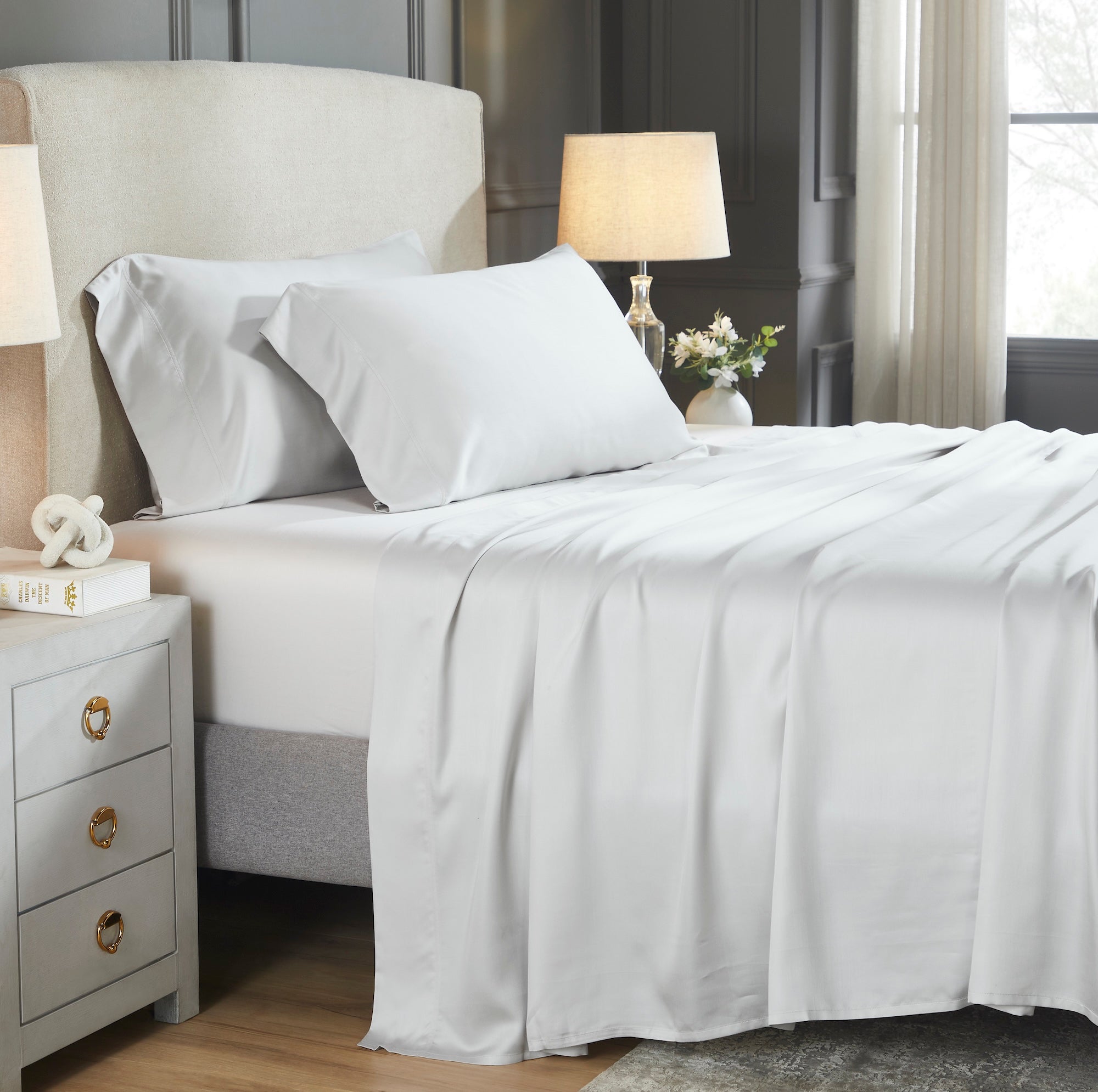 CSS-528-7284_1|Luxurious white 100% Lyocell sheets draped on a bed, providing a silky smooth, breathable, and eco-friendly sleep experience.