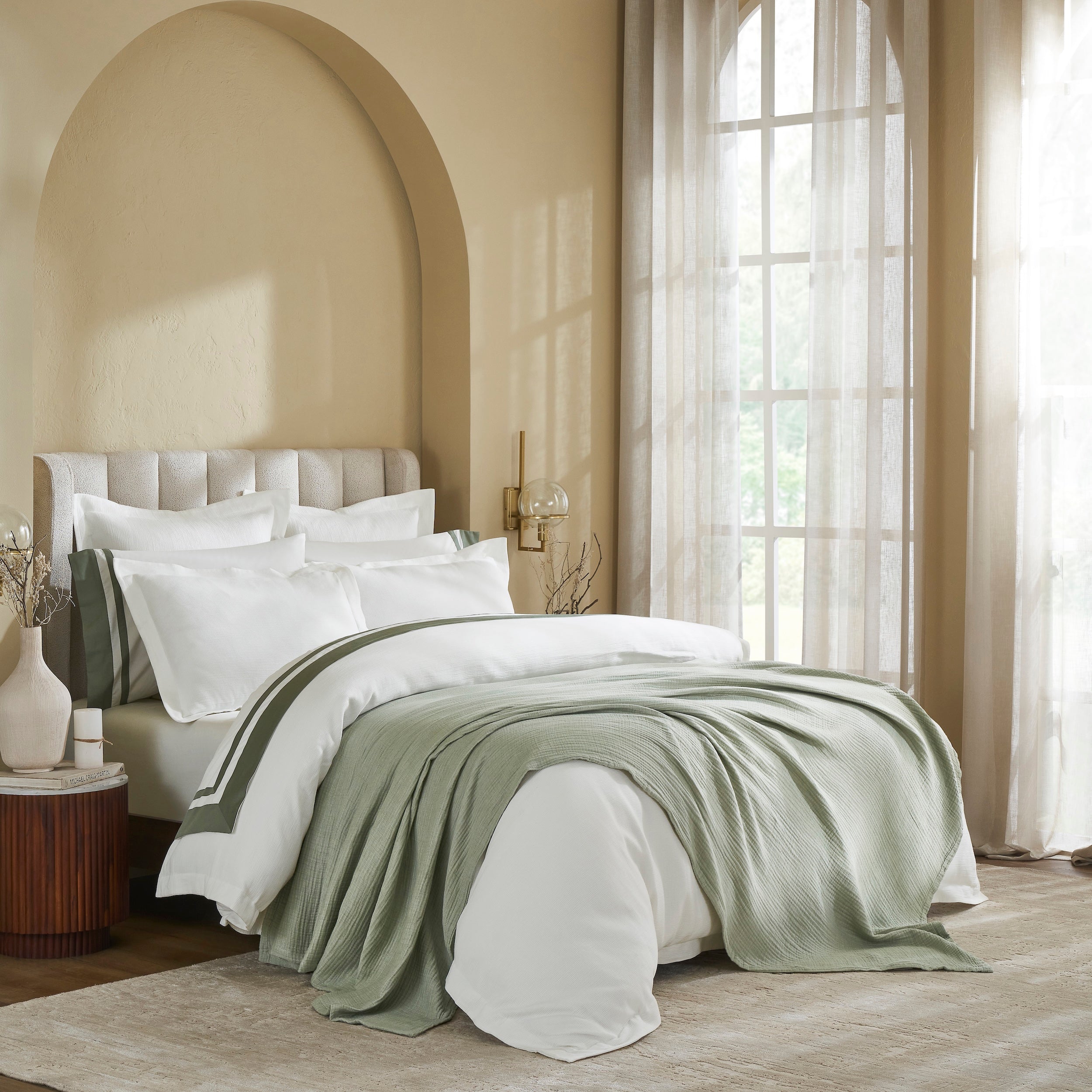 BL-864-9496_3|Elegant bedroom showcasing a light green textured blanket draped over plush white bedding, enhancing comfort and style.