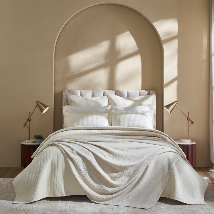 CL-271-11096_6|Luxurious cream textured coverlet, beautifully draped on a bed. Soft, inviting bedding for a comfortable and stylish bedroom.