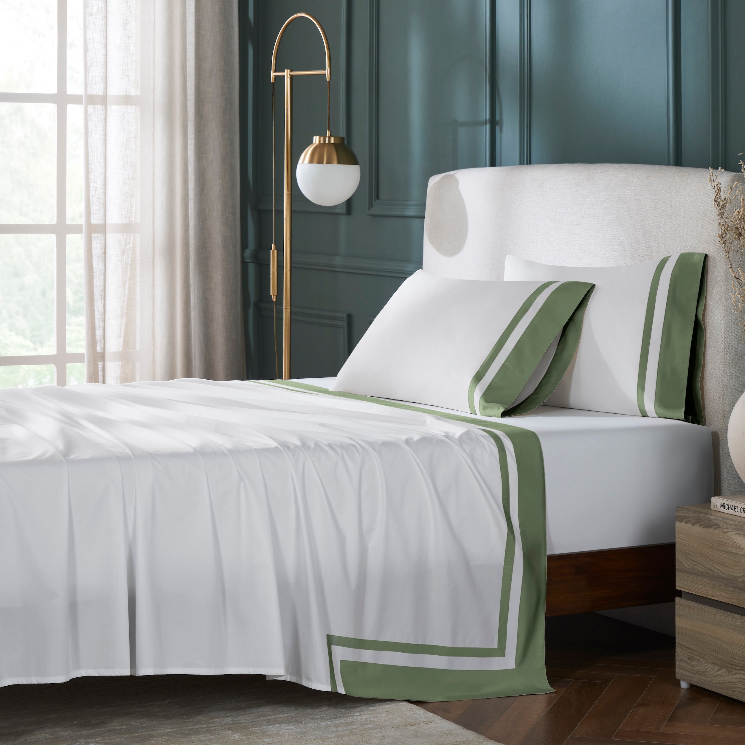 QFL-542-6080_1|Luxurious 100% cotton sheets on a bed, featuring crisp white fabric with a stylish green border. Includes matching pillowcases.