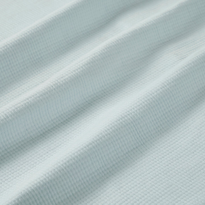 BL-859-9496_9|Draped and folded light blue waffle-weave blanket fabric, soft and inviting, perfect for stylish layering in bedroom decor.