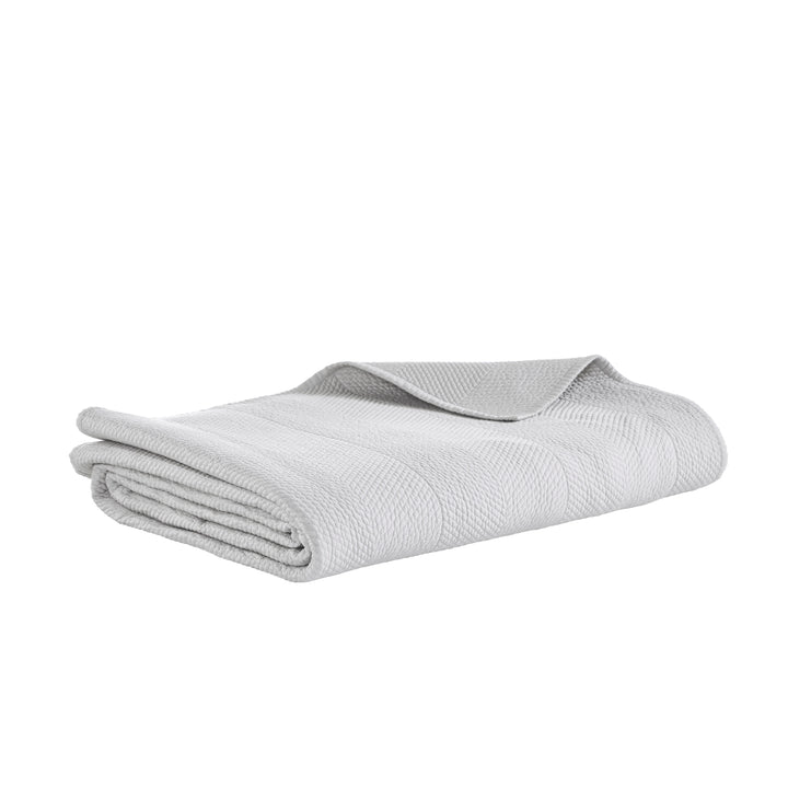 CL-172-11096_6|Soft light grey quilted coverlet with a distinctive herringbone texture, elegantly folded for versatile bedroom use.