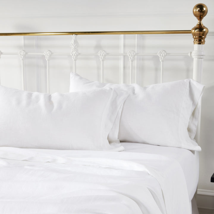 QSS-514-6080_3|Fresh white 100% linen sheet set with matching pillowcases on a bed, offering exceptional softness and breathability.