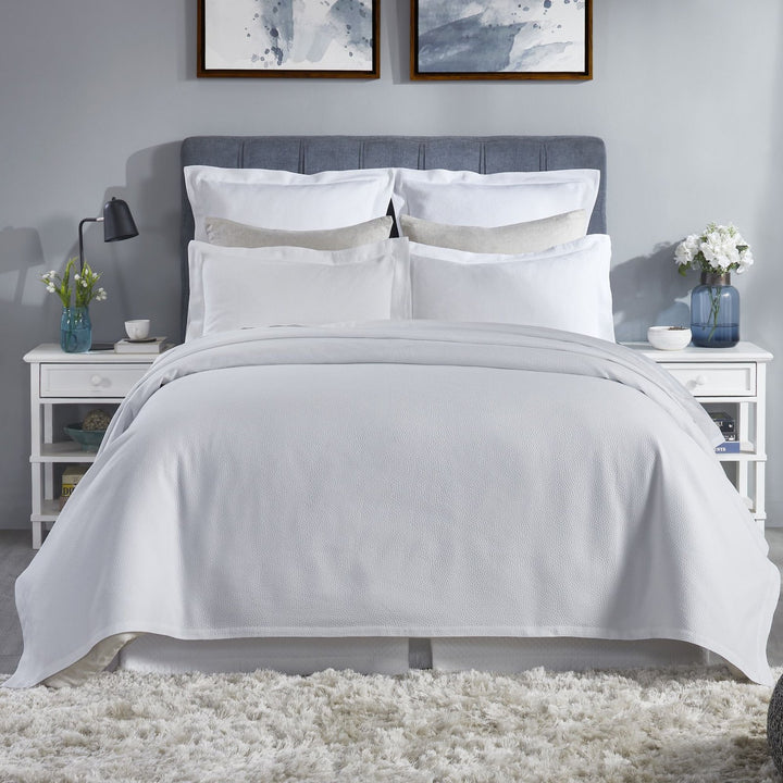 CL-258-9496_1|Crisp white coverlet featuring a delicate, subtle dimpled texture for a modern and clean bedroom design.