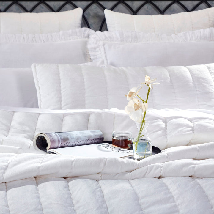 QT-337-9496_3|Close-up of a soft white textured quilt with elegant channel quilting. Provides cozy comfort and a clean, modern look.