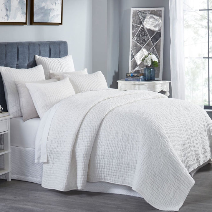 QT-359-9496-LOT1_2|Crisp white quilted duvet cover and shams adorning a stylish bedroom setting. Textured cotton quilt adds comfort and elegance.