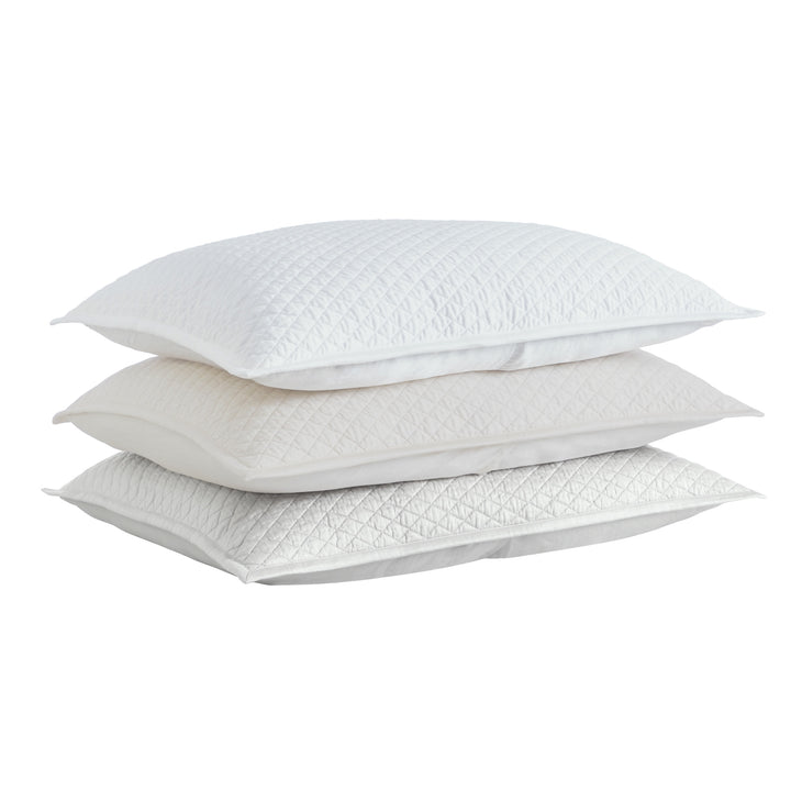 SS-264-2026_3|Stack of white, cream, and grey quilted coverlets with diamond pattern. Versatile bedding options for elegant bedroom styling.