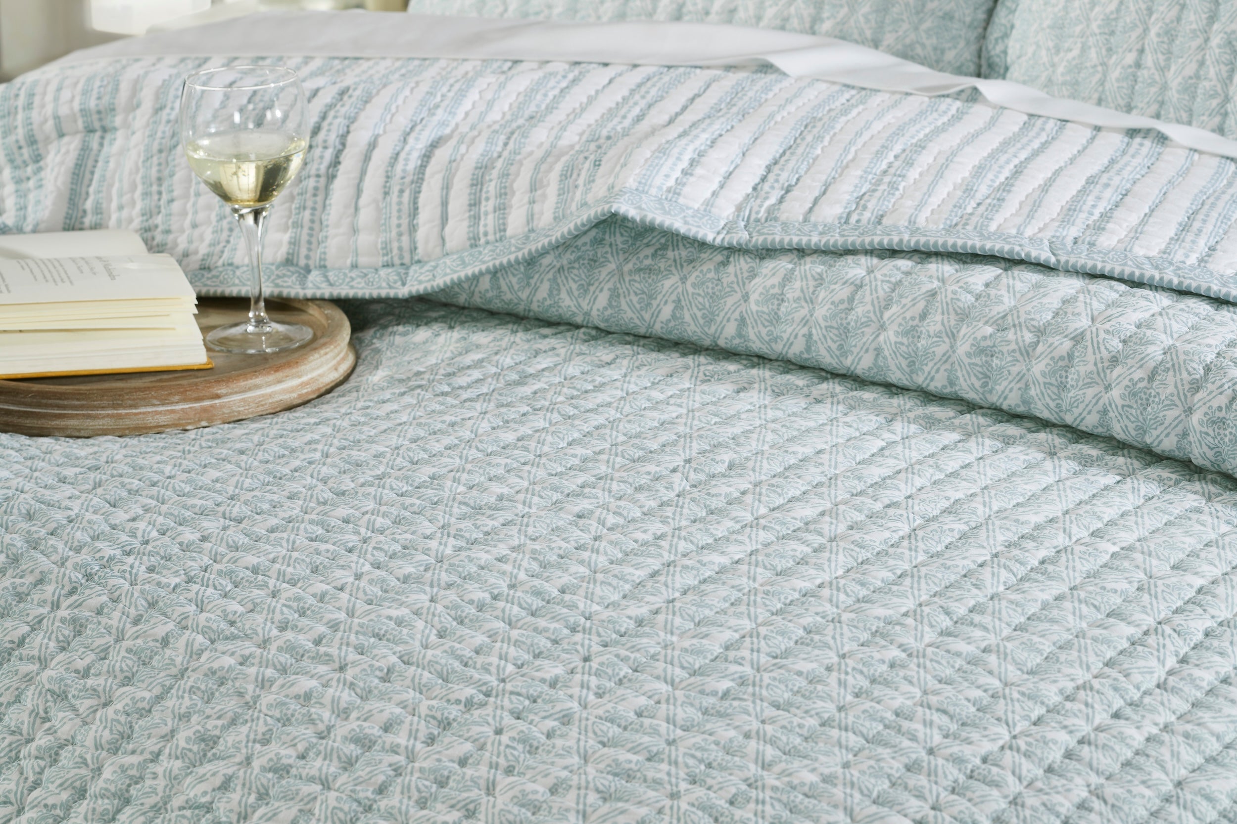 QT-347-11096_4|Luxurious blue patterned quilt on a bed, highlighting detailed texture and a serene feel, perfect for a cozy and relaxing bedroom.