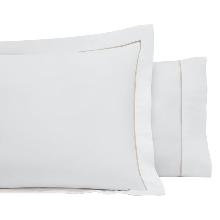 AKP-531-2040_3|Elegant pair of 100% cotton white pillowcases with sophisticated beige piping, offering luxurious bedroom comfort.