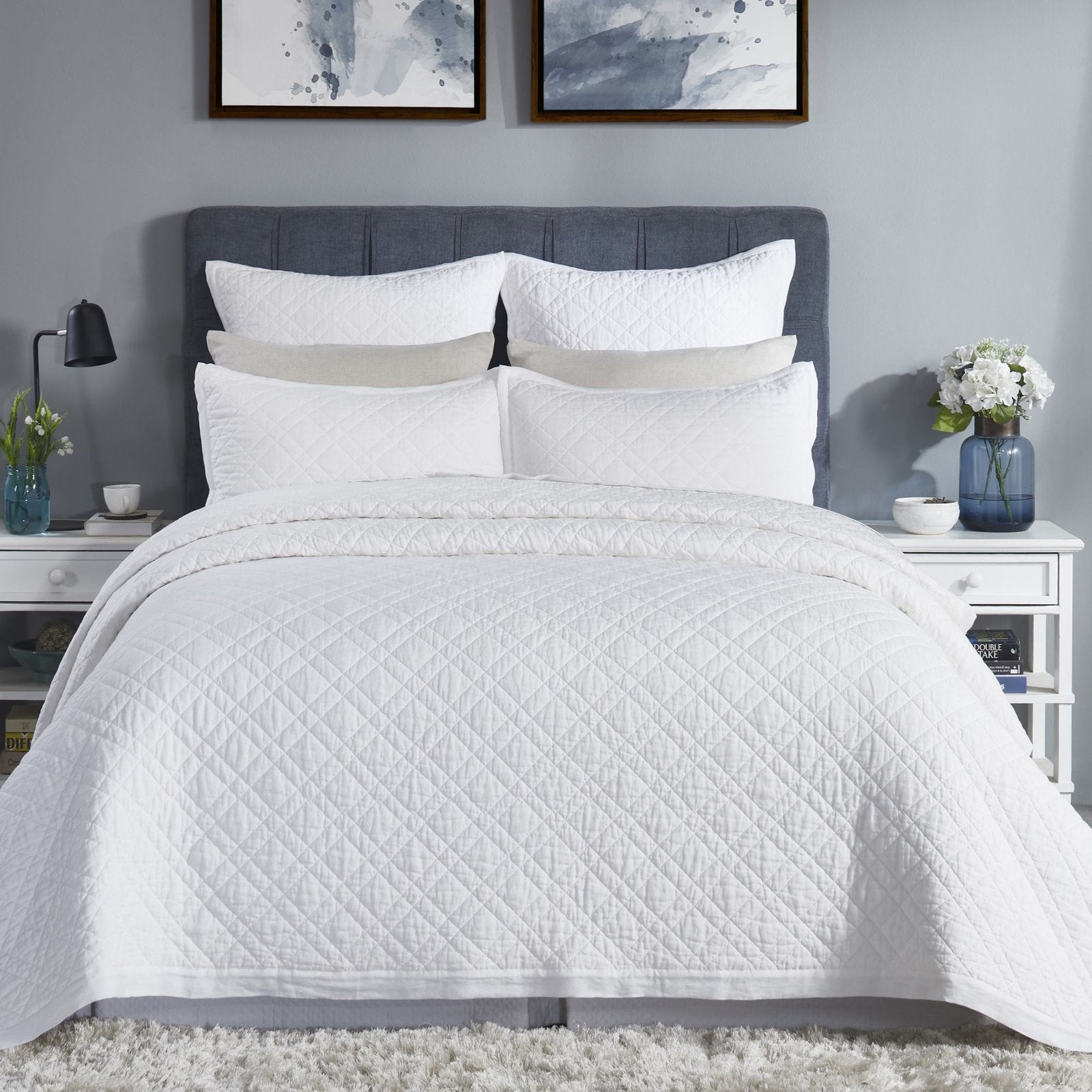 CL-253-11096_1|Crisp white quilted coverlet elegantly adorning a modern bed, offering serene comfort and timeless style for any bedroom.