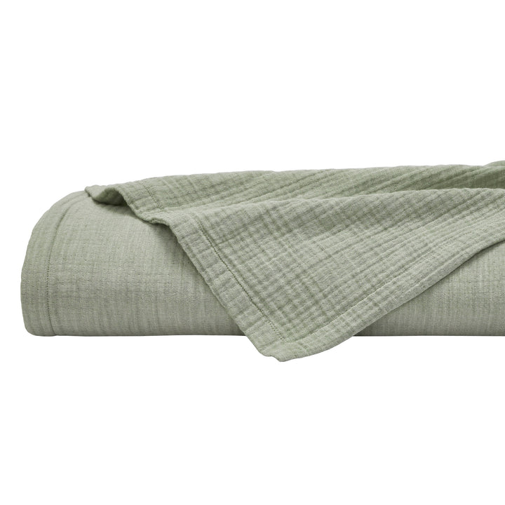 BL-864-9496_6|Neatly rolled sage green textured blanket, showcasing its plushness and cozy fabric, perfect for bedroom comfort and style.