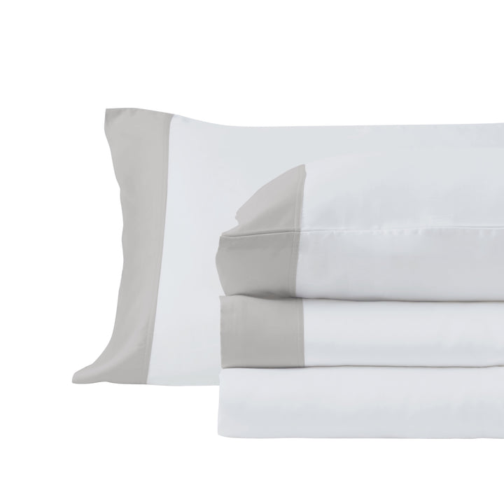 CSS-529-7284_3|Stacked crisp white 100% Lyocell sheet set with elegant beige border, including a pillowcase, on white background.