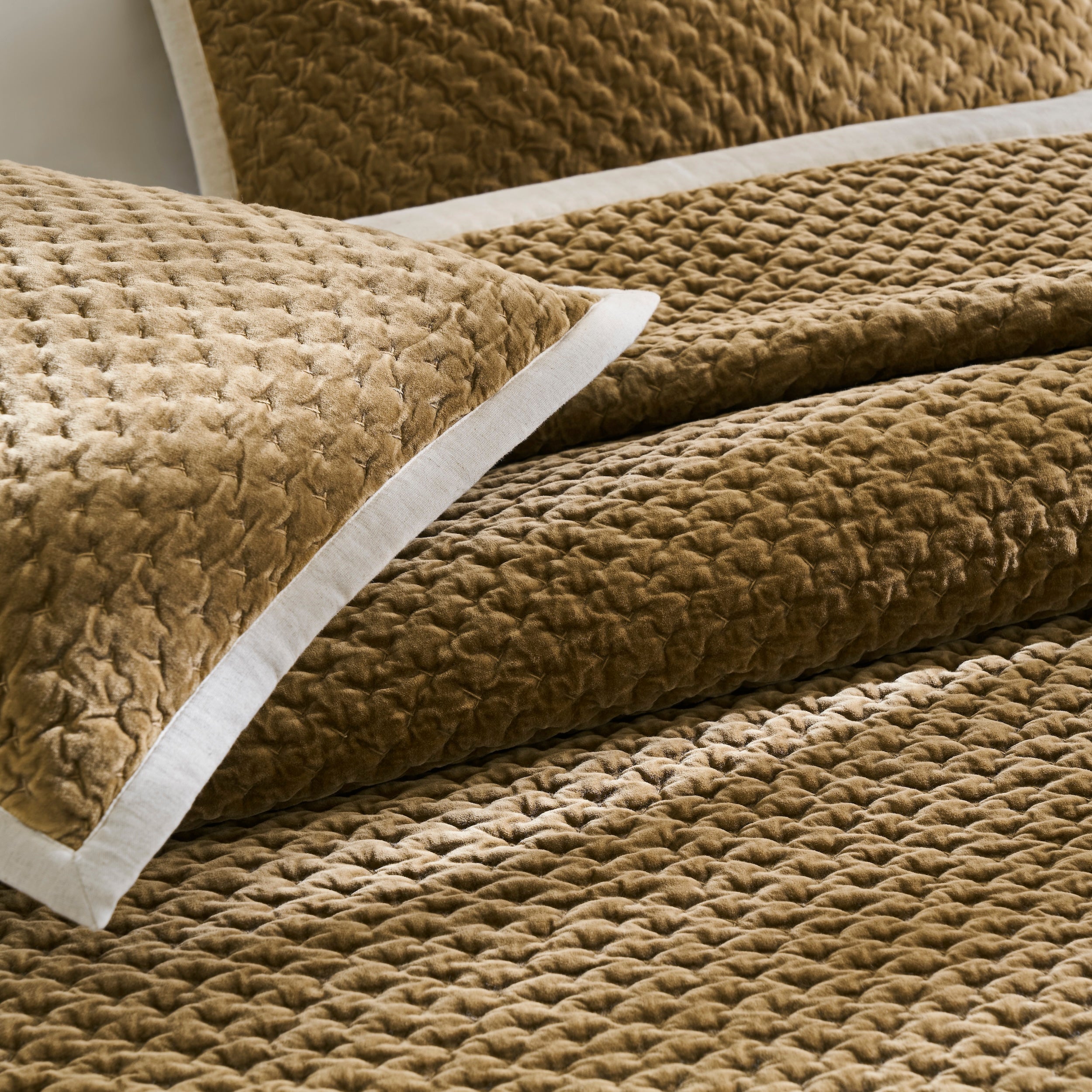 QT-378-9496_6|Close-up of golden brown quilted velvet pillow and textured bedspread, highlighting plush, soft, and luxurious bedding.