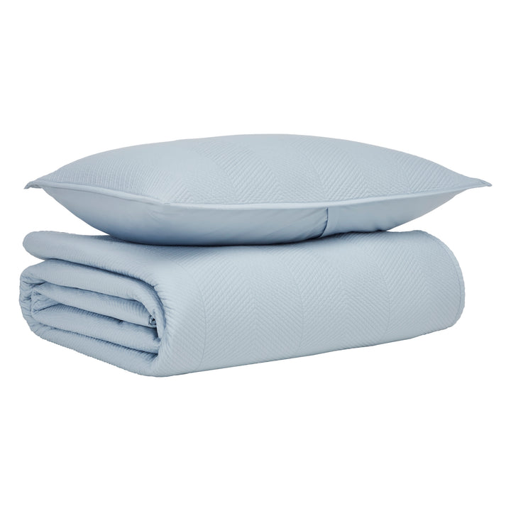 CL-262-9496_5|Folded light blue quilted coverlet featuring a crisp herringbone pattern, paired with a matching pillow for stylish bedding.