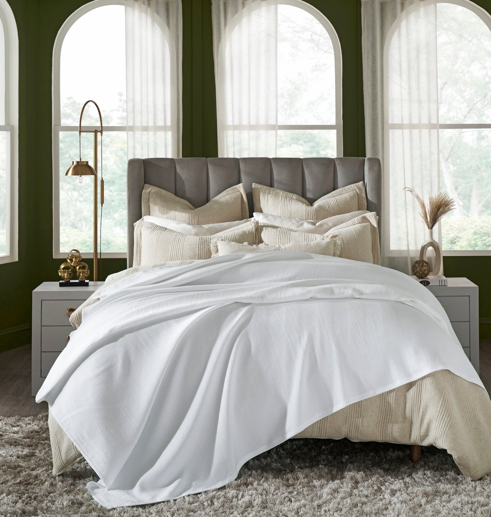 BL-858-9496_1|Luxurious white waffle weave blanket gracefully draped over a beige bed in a sophisticated green bedroom. Cozy elegance.