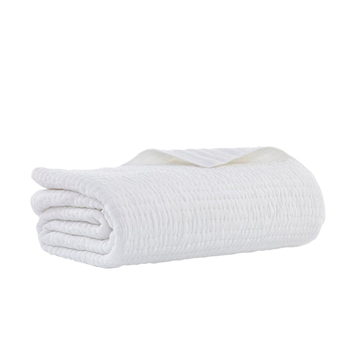 QT-358-9496_6|Neatly folded white quilted blanket with subtle textured stripe pattern, offering minimalist elegance and cozy comfort.