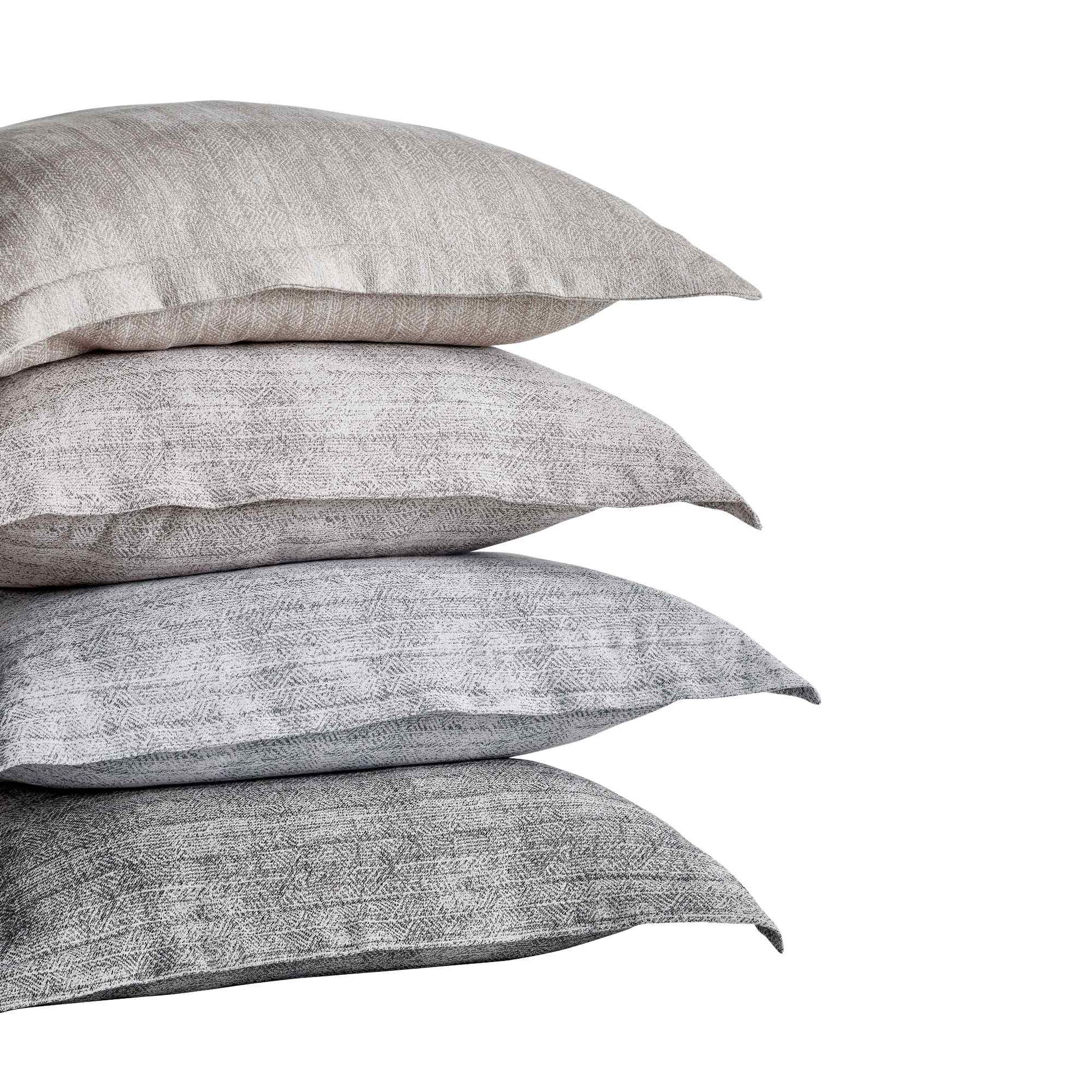 SS-032-X_1|Stack of four textured decorative throw pillows in varying natural and grey tones, ideal for modern home accents.