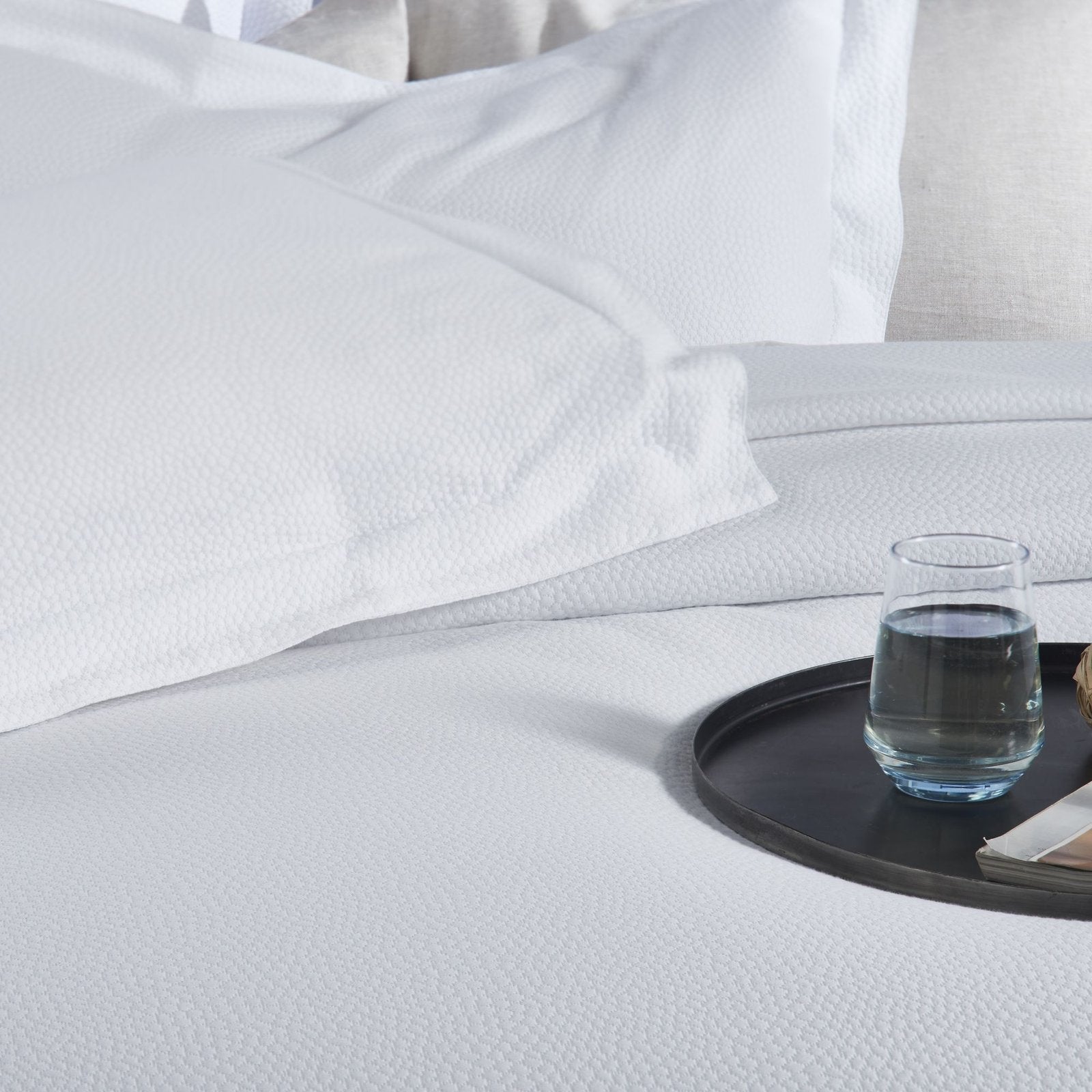 CL-258-11096_4|Crisp white coverlet featuring a delicate, subtle dimpled texture for a modern and clean bedroom design.