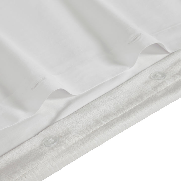 DT-052-9092_7|Close-up of crisp white luxury duvet cover with subtle textured stripe detail and elegant button closure. Premium bedding.