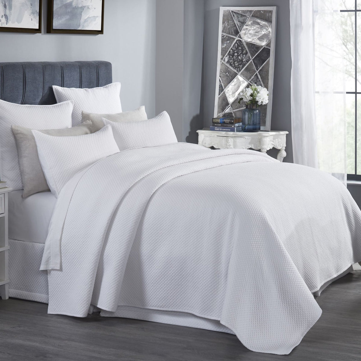 CL-200-9496_2|White quilted coverlet elegantly drapes a queen bed in a bright, modern bedroom, inviting comfort.