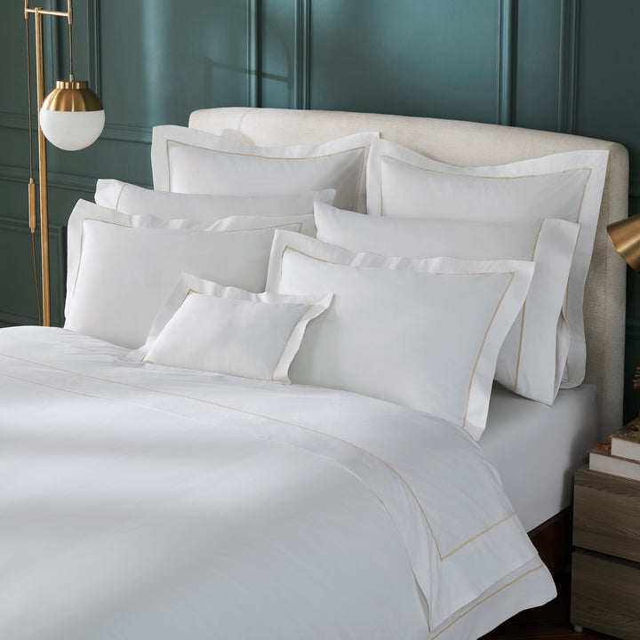 DT-056-9092_2|Elegant white duvet cover with subtle golden trim, providing luxurious hotel-quality bedding for a sophisticated bedroom.