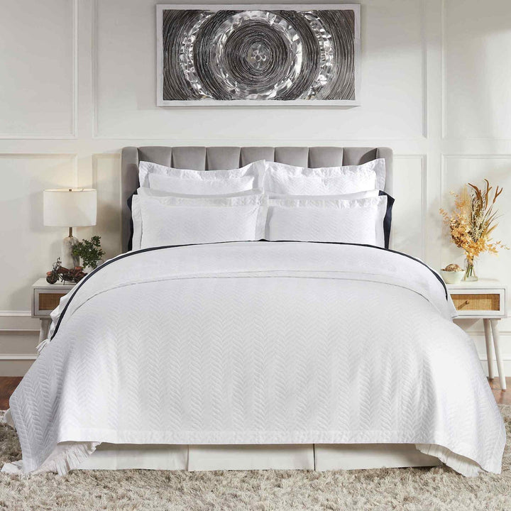 CL-194-X_1|Elegant white chevron textured quilt with matching white pillows, creating a fresh, tailored look for a contemporary bedroom setting.