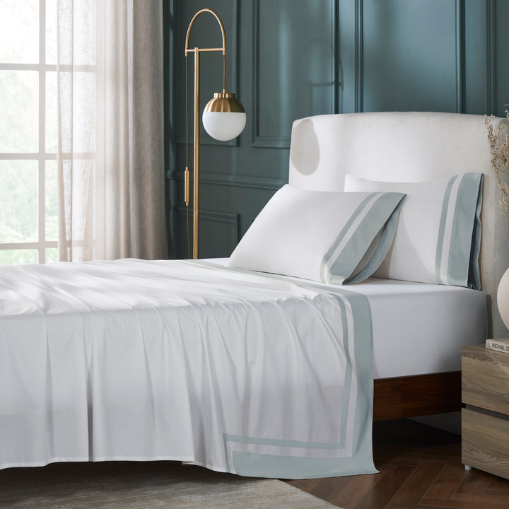 QFL-541-6080_1|Elegant 100% cotton sheets set, featuring crisp white fabric and stylish light blue striped borders, perfect for a cozy bed.