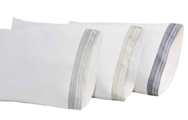 ASP-502-2032_2|Stack of three luxurious white 100% cotton pillowcases with varying embroidered trims for elegant bedding.