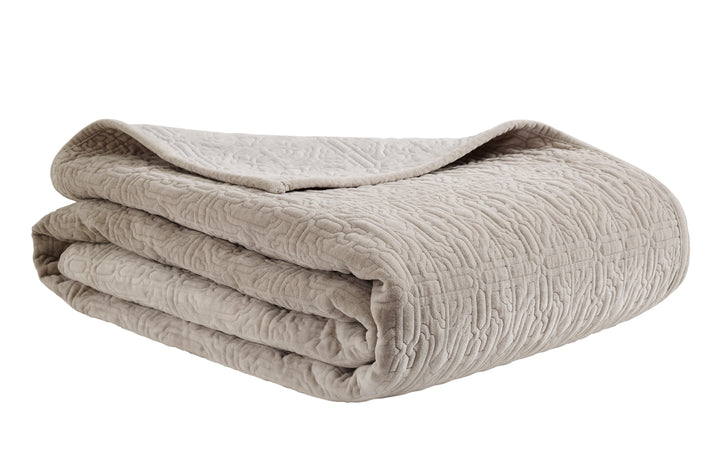 QT-331-11096_4|Soft tan quilted bedspread, meticulously folded, featuring a subtle textured pattern for cozy, refined bedding.