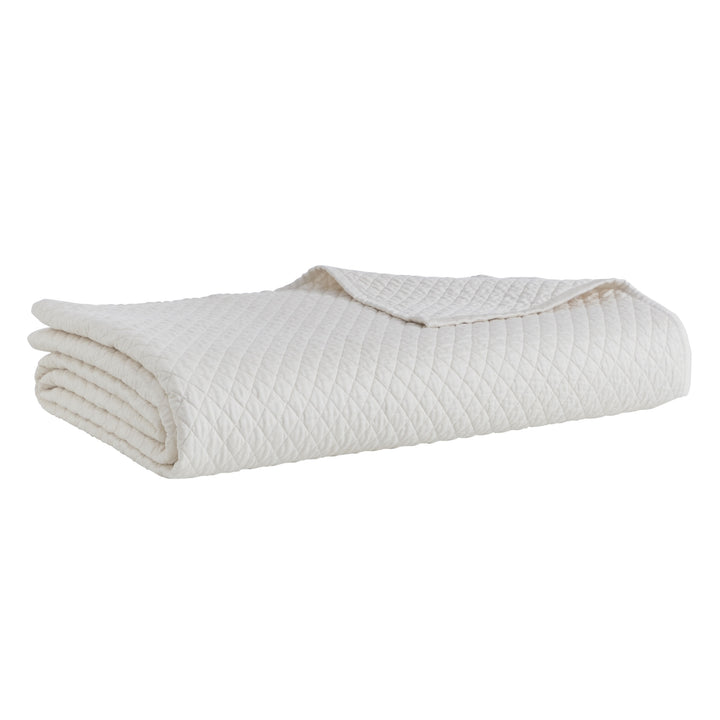 CL-265-9496_5|Neatly folded white diamond quilted coverlet, showcasing its elegant pattern. Premium quality and soft, pristine bedding.