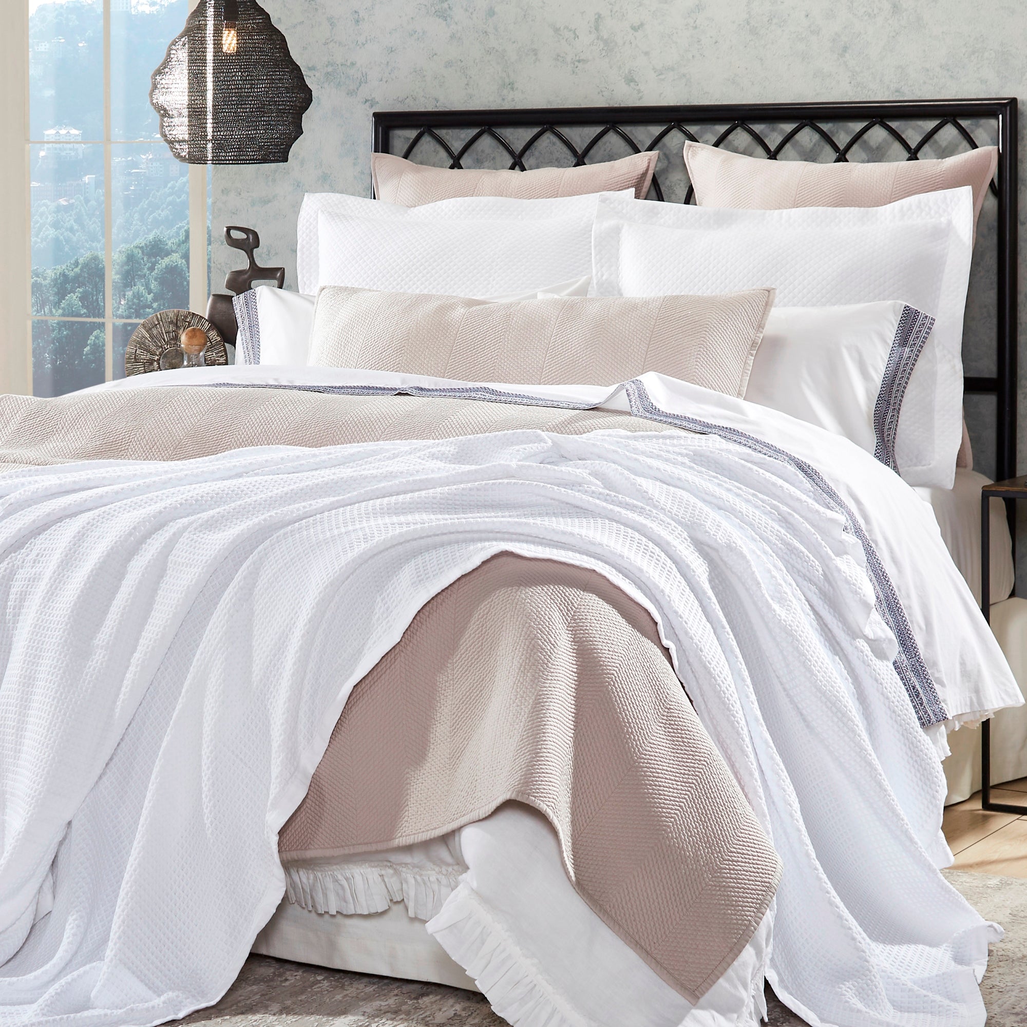 BL-855-11096_1|Elegant white waffle weave blanket layered with a cozy light pink throw on a stylish bed, perfect for a modern bedroom.