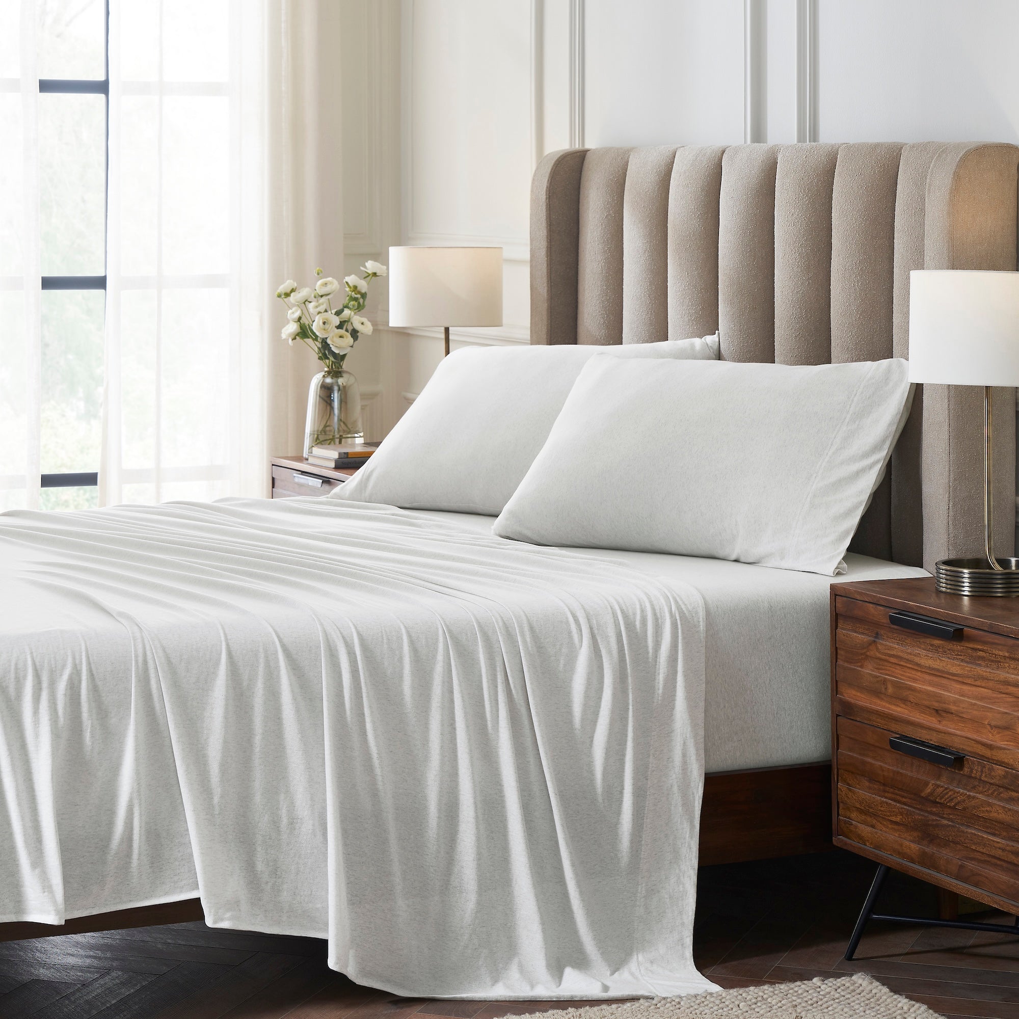 QSS-525-6080_1|Crisp white 100% cotton jersey sheet set and pillowcases on a bed, for a clean and inviting bedroom look.