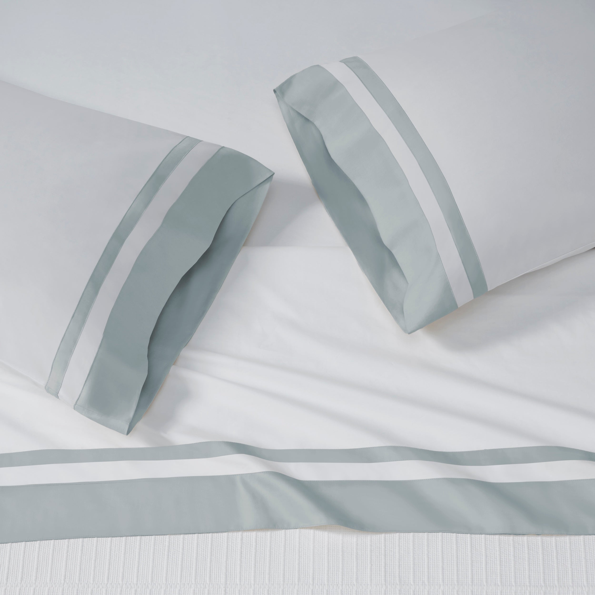 ASP-541-2032_2|White 100% cotton sateen flat sheet and two pillowcases, each featuring a wide light blue border with dual white stripes.