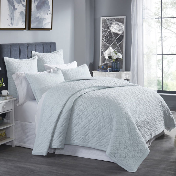 CL-255-9496_2|Serene light blue quilted coverlet dressing a modern bedroom, featuring a subtle diamond pattern for stylish comfort.