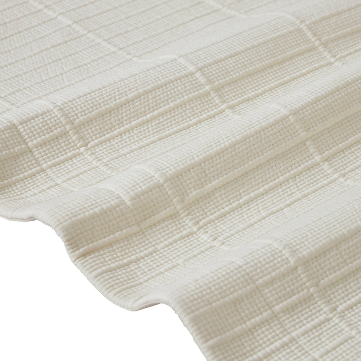 CL-271-11096_12|Close-up of elegant cream textured coverlet fabric, showcasing intricate ribbed and square patterns, soft and stylish bed linen.
