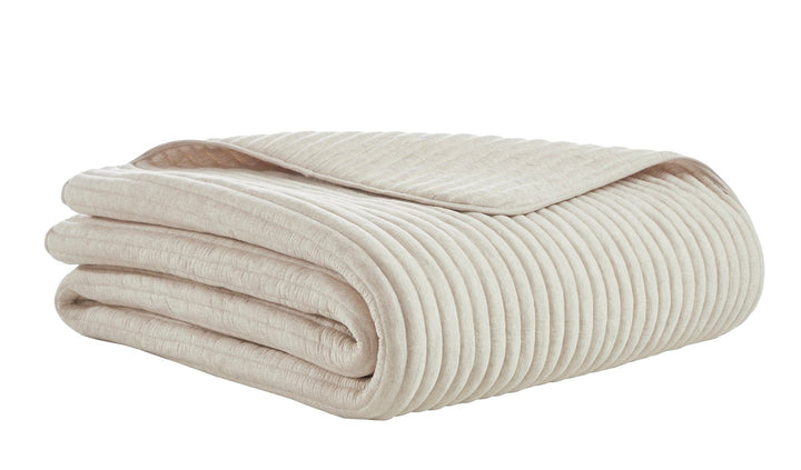 QT-368-11096_5|Folded beige ribbed quilted quilt, highlighting its soft texture and distinctive vertical stripe pattern for beds.