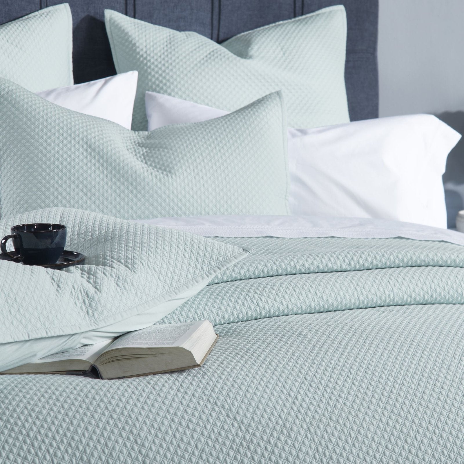 CL-252-11096_4|Intimate close-up of a refreshing mint green quilted coverlet, emphasizing its soft, intricate texture for luxurious bedding.