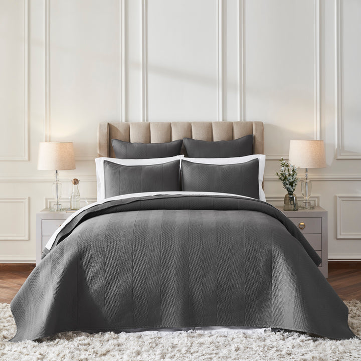 CL-263-11096_1|Sophisticated charcoal grey quilted coverlet with a stylish herringbone pattern on a bed in an elegant bedroom setting.