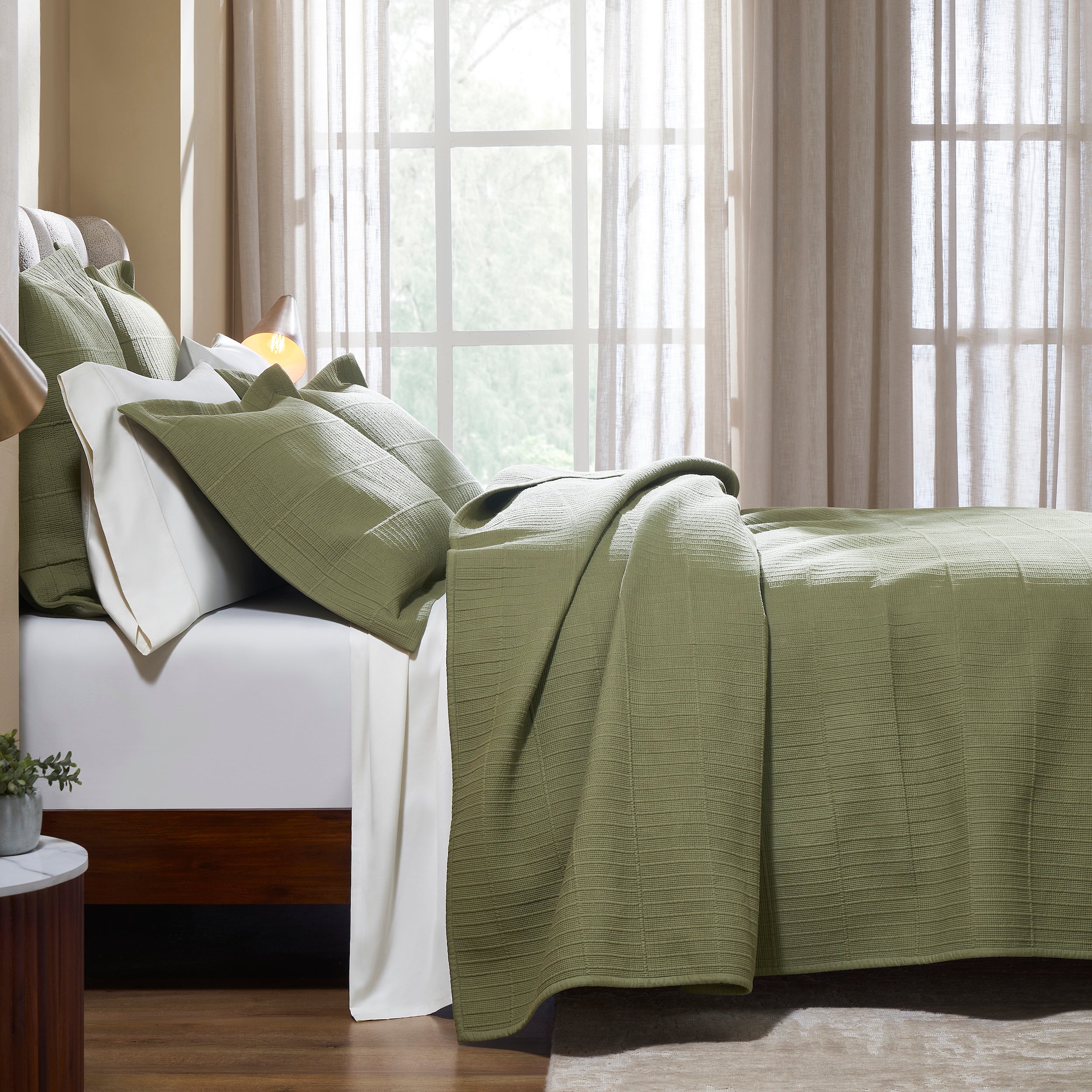 CL-270-9496_3|Side view of a bed dressed with a sage green textured cotton blend coverlet and matching pillows, cozy sleep.