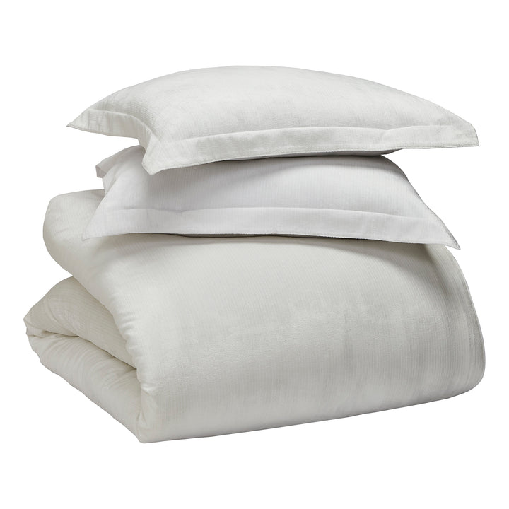 KS-052-2036_4|White textured duvet cover, folded neatly in a stack. Crafted from soft, breathable fabric, perfect for a cozy and inviting bed.