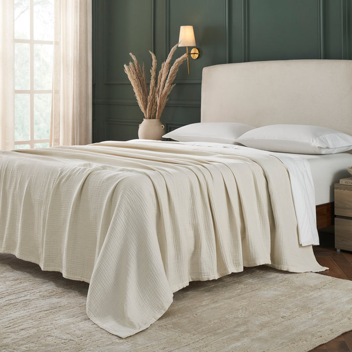 BL-862-9496_2|Full view of a light beige cotton blanket covering a bed, providing cozy warmth and a stylish, textured finish.