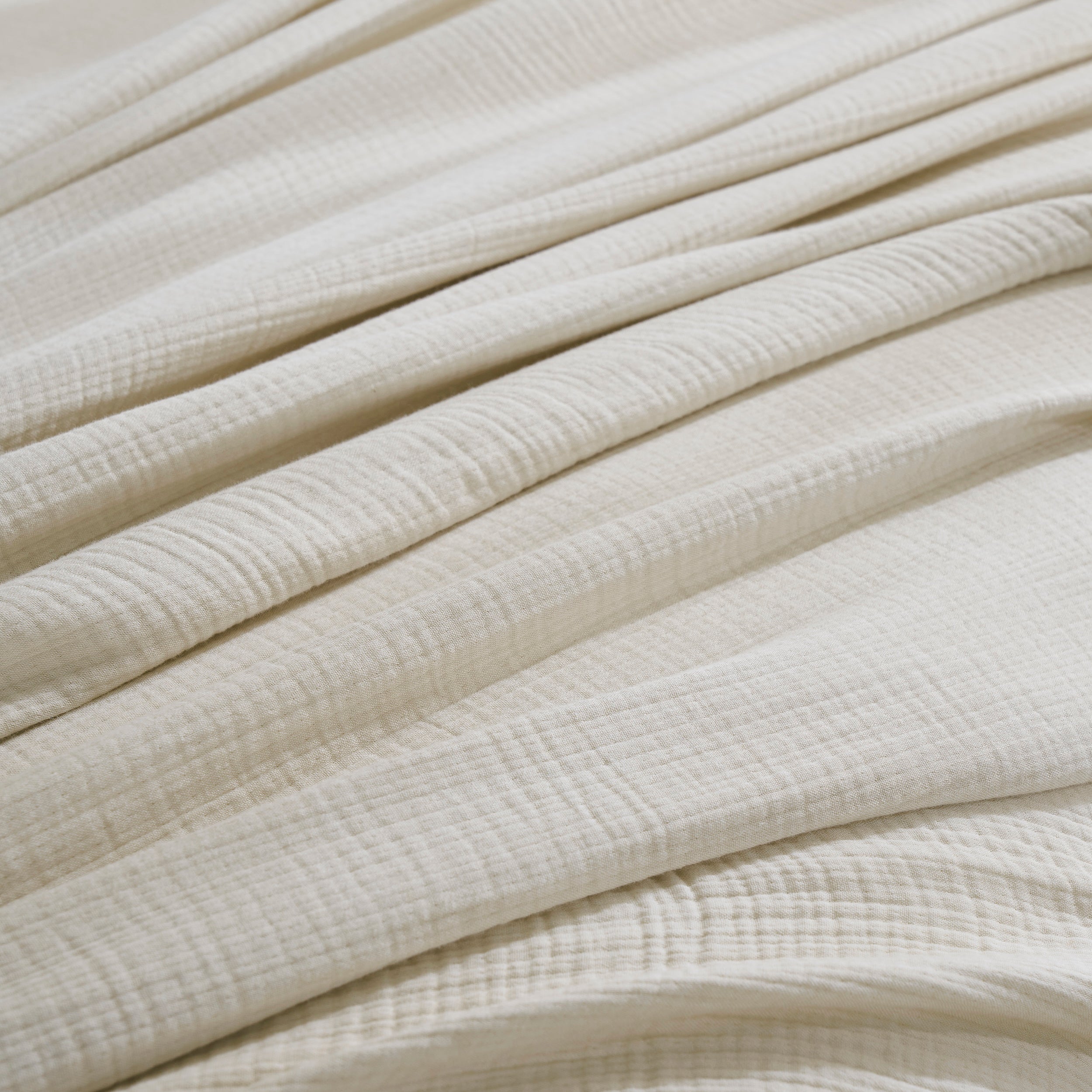 BL-862-9496_5|Close-up of soft light beige textured cotton blanket, highlighting its delicate folds and breathable, cozy fabric.