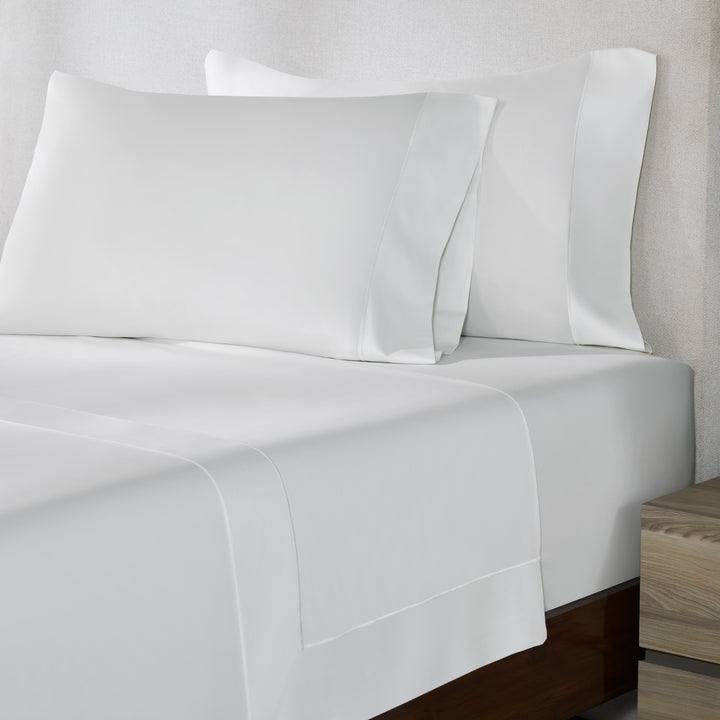 TFL-533-3980_2|Close-up of crisp 100% cotton white sheets and pillowcases, showcasing pure elegance for a minimalist and serene bed.