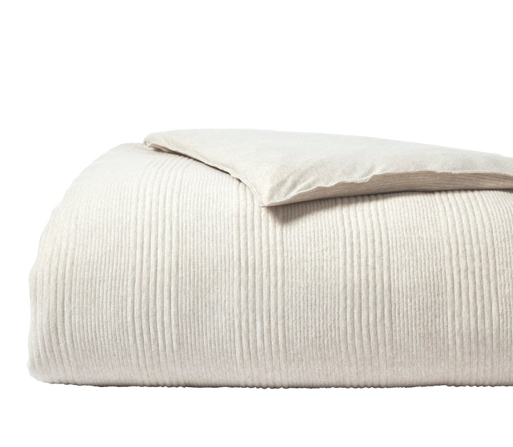 DT-040-9092_5|Clean beige textured duvet cover, vertically ribbed fabric, neatly folded with a matching pillow on top, simple elegance.
