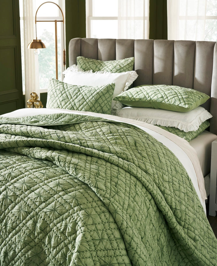 QT-366-11096_3|Close-up of a vibrant green textured quilt set showcasing intricate geometric patterns, adding a refreshing and cozy feel to the bed.