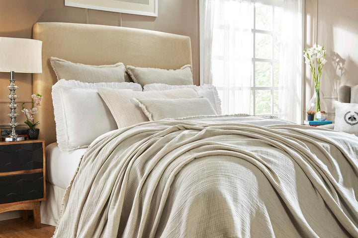 BT-102-11096_1|Soft beige textured blanket beautifully draped over a bed, adding warmth and sophistication to any bedroom setting.